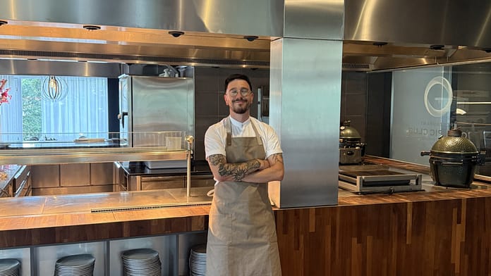 Tiago Pereira, performance chef for London City Lionesses, standing confidently in a professional kitchen.