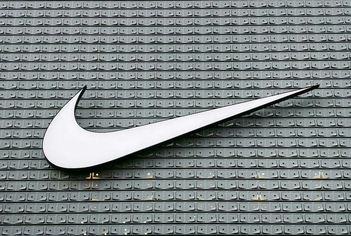 Nike Store Swoosh The Nike swoosh logo on a patterned wall, symbolising one of the most iconic sports marketing brands in the world.