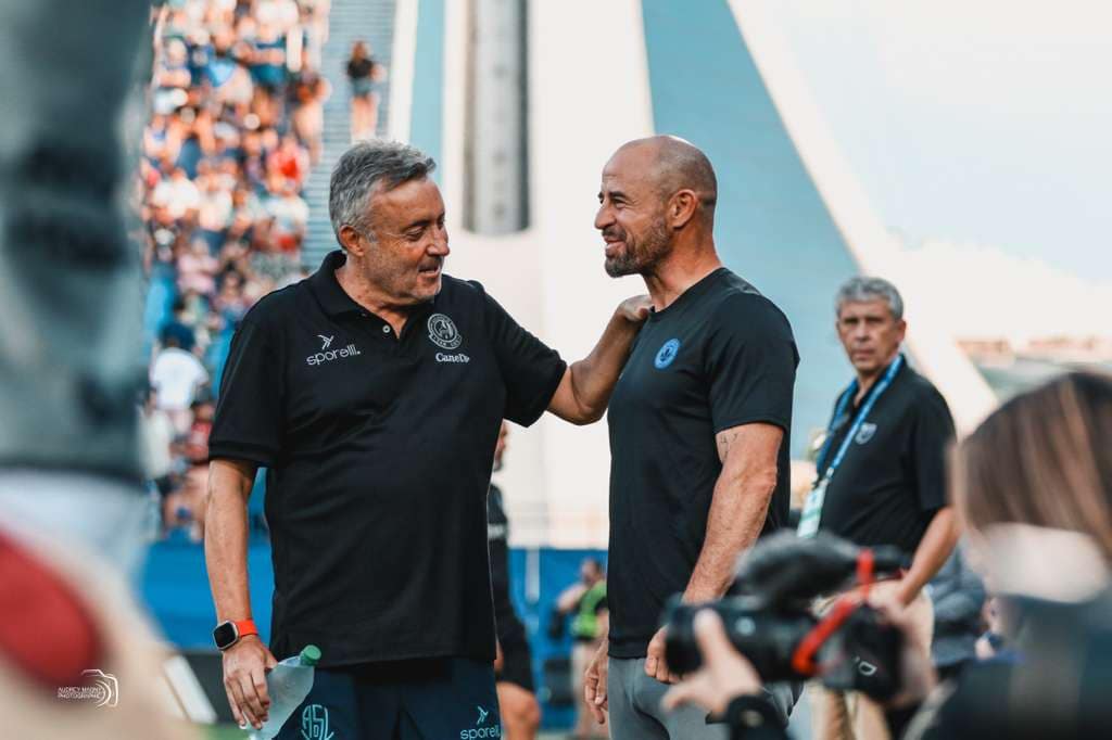 Laurent Courtois sharing a moment with another coach before a CF Montréal match at Stade Saputo.