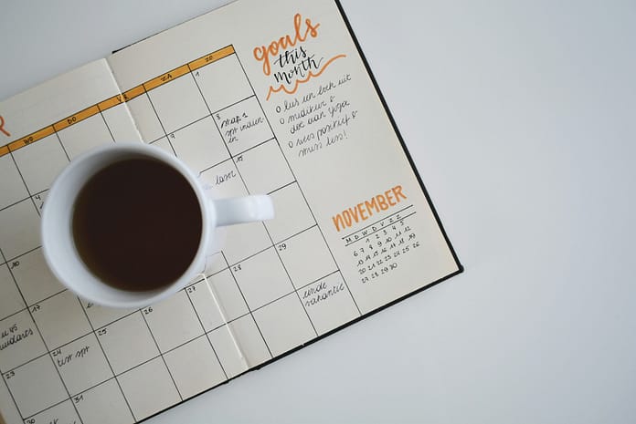 estee-janssens-aQfhbxailCs-unsplash a coffee cup over a book