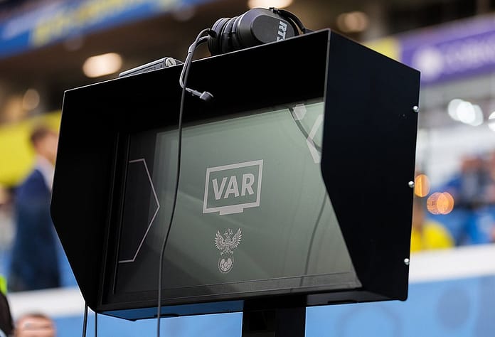 VAR monitor on the sidelines during a football match in Russia, used for video assistant referee decisions.